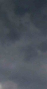 MATTHEW SWARTS DARK, CLOUDY SKY WITH THICK, GRAY CLOUDS COVERING MOST OF THE VIEW, CREATING AN OVERCAST, MOODY ATMOSPHERE.