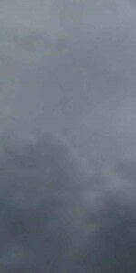 MATTHEW SWARTS FOGGY OR CLOUDY SKY WITH FAINT OUTLINES OF MOUNTAINS OR TREES BARELY VISIBLE IN THE BACKGROUND, CREATING A GRAY, MISTY AND MYSTERIOUS ATMOSPHERE.