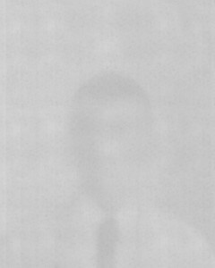 MATTHEW SWARTS A VERY BLURRY AND FADED GRAYSCALE VISUAL, POSSIBLY FROM A VIDEO, SHOWS A VAGUE OUTLINE OF A PERSON IN A SUIT AND TIE—PERHAPS MATTHEW SWARTS—MAKING FACIAL FEATURES AND DETAILS INDISTINGUISHABLE.