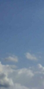 MATTHEW SWARTS A BLURRY IMAGE OF A BLUE SKY WITH A FEW SCATTERED WHITE CLOUDS. THE CLOUDS ARE MOSTLY NEAR THE BOTTOM OF THE IMAGE, AND THE REST OF THE SKY APPEARS CLEAR.