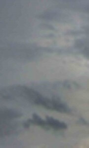 MATTHEW SWARTS A BLURRY IMAGE OF AN OVERCAST SKY WITH VARIOUS SHADES OF GRAY CLOUDS DISPERSED THROUGHOUT.