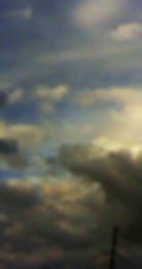MATTHEW SWARTS A BLURRY IMAGE OF A CLOUDY SKY WITH VARYING SHADES OF GRAY, BLUE, AND YELLOW. THE CLOUDS ARE SCATTERED, CREATING A SOFT, HAZY EFFECT WITH SUNLIGHT PEEKING THROUGH IN SOME AREAS.