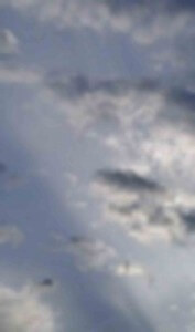 MATTHEW SWARTS A BLURRY IMAGE OF A CLOUDY SKY WITH VARIOUS SHADES OF BLUE AND GRAY, SHOWING SCATTERED CLOUDS AND SOFT, DIFFUSED LIGHT.