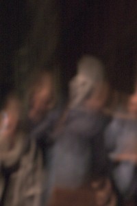 MATTHEW SWARTS A BLURRY IMAGE SHOWING INDISTINCT FIGURES SITTING CLOSELY TOGETHER, POSSIBLY IN AN INDOOR SETTING—DETAILS AND FACES ARE NOT CLEAR DUE TO MOTION BLUR, REFLECTING THE ART STYLE OF MATTHEW SWARTS.