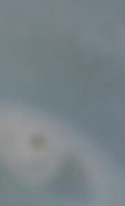 MATTHEW SWARTS A BLURRY IMAGE WITH MOSTLY BLUE AND GRAY TONES AND AN INDISTINCT, PALE CIRCULAR SHAPE IN THE LOWER LEFT AREA. THE IMAGE LACKS CLEAR DETAILS OR RECOGNIZABLE OBJECTS.