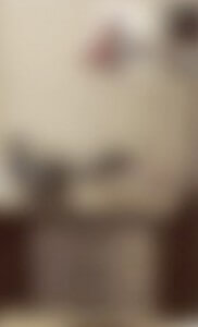 MATTHEW SWARTS THE IMAGE IS VERY BLURRY AND INDISTINCT, MAKING IT DIFFICULT TO IDENTIFY ANY OBJECTS OR DETAILS CLEARLY. THE COLORS APPEAR MUTED WITH BEIGE AND BROWN TONES.