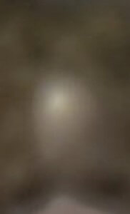 MATTHEW SWARTS A BLURRY, OUT-OF-FOCUS IMAGE WITH A BROWNISH BACKGROUND AND A PALE, CIRCULAR SPOT IN THE CENTER. THE DETAILS ARE INDISTINGUISHABLE.