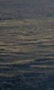 MATTHEW SWARTS A CLOSE-UP VIEW OF GENTLY RIPPLING WATER, SHOWING SUBTLE WAVES AND REFLECTIONS ON THE SURFACE.