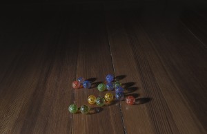 MATTHEW SWARTS SEVERAL COLORFUL GLASS MARBLES, INCLUDING BLUE, GREEN, YELLOW, AND RED, ARE SCATTERED ON A DARK WOODEN FLOOR WITH VISIBLE GRAIN PATTERNS. THE SCENE HAS A CONTEMPORARY FEEL, AS LIGHT SHINES ON THE MARBLES AND CASTS SOFT SHADOWS.