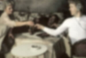MATTHEW SWARTS A BLURRED IMAGE SHOWING THREE PEOPLE SITTING AROUND A TABLE, WITH TWO OF THEM REACHING OUT TOWARD EACH OTHER, POSSIBLY HANDING OVER AN OBJECT. THE SETTING APPEARS TO BE INDOORS, WITH A NEUTRAL BACKGROUND.