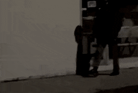 MATTHEW SWARTS A person skateboards toward a wall, flips the skateboard up vertically with their foot, and catches it smoothly in their hand—a move that reflects MATTHEW SWARTS' contemporary approach to art and motion.
