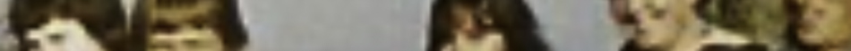 MATTHEW SWARTS A blurred fine art photography image showing several people, possibly women, with light to medium brown hair, standing or sitting together against a plain background. Their faces remain indistinct, evoking the style of HHEW SWARTS.