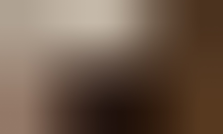 MATTHEW SWARTS The image is very blurred, featuring warm brown and beige tones, with no distinct shapes or objects visible—a subtle nod to contemporary art styles reminiscent of Matthew Swarts.