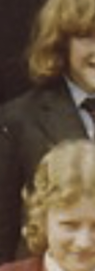MATTHEW SWARTS A cropped, blurry photo by artist Matthew Swarts shows two people with curly hair in jackets; only the upper part of their faces and shoulders are visible.