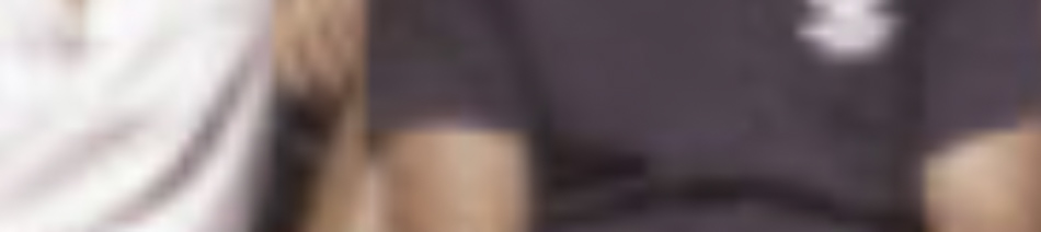 MATTHEW SWARTS Two people sit side by side in this very blurry image by artist and photographer Matthew Swarts. Their facial features and surroundings fade into abstraction, with one in a white top and the other in a dark top.