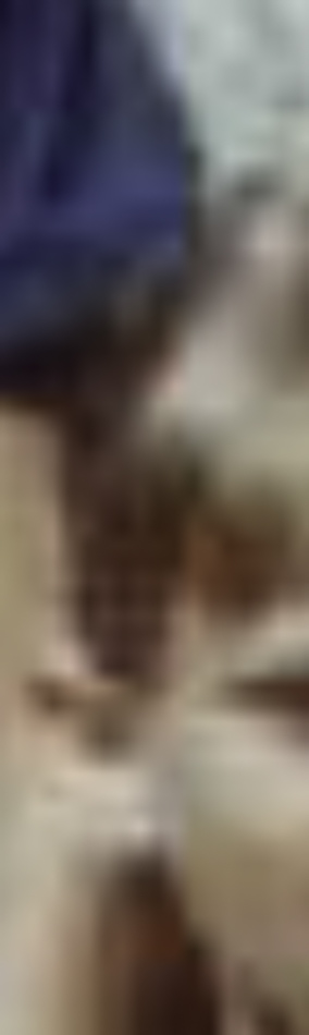 MATTHEW SWARTS A blurry, close-up image with indistinct shapes and colors—beige, brown, and blue—captures a contemporary ART style. The details are unclear, leaving the subject unidentifiable and open to interpretation.