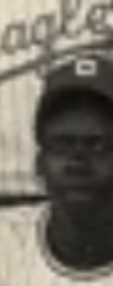 MATTHEW SWARTS A blurry, sepia-toned photo by MATTHEW SWARTS shows a person in a baseball cap and jersey. The CONTEMPORARY background features partial, faded text on a wall or sign.