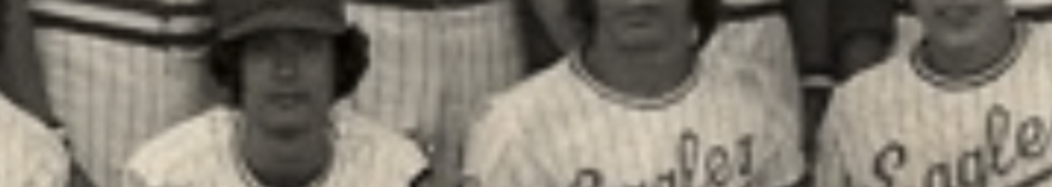 MATTHEW SWARTS A cropped, sepia-toned photo by artist MATTHEW SWARTS shows two people wearing striped baseball uniforms with the word “Eagles” partially visible. Both face the camera; one wears a cap. Only their upper bodies are visible.