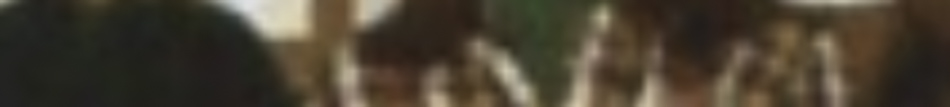 MATTHEW SWARTS A very blurry image with indistinct shapes and colors, possibly showing people sitting at a table indoors. Details and faces are not clear, suggesting an abstract style often explored in ART or experimental PHOTOGRAPHY.