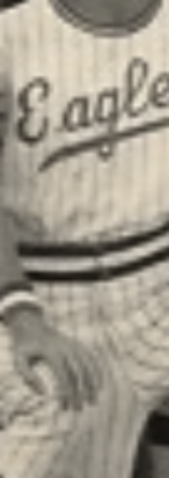 MATTHEW SWARTS Black and white photo showing the torso of a person wearing a striped baseball uniform with Eagles written across the chest. This striking example of contemporary art captures only part of the arm and leg, echoing the spirit of visual art.