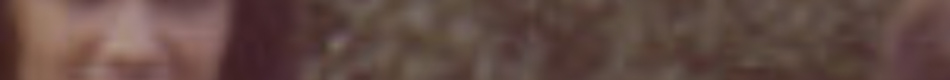MATTHEW SWARTS A blurry close-up image, reminiscent of MATTHEW SWARTS' art, shows part of a face on the left and brown, wavy hair on the right, with the overall photo lacking clear details.