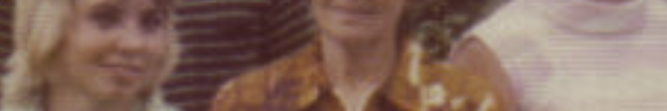MATTHEW SWARTS A blurry, cropped vintage photo showing three people; two wear patterned shirts and one is in white, all partially visible and smiling—capturing a spontaneous moment reminiscent of contemporary art.