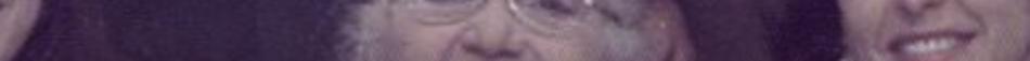 MATTHEW SWARTS A close-up, blurry and distorted fine art photography image showing parts of three faces with unclear expressions, set against a purple-tinted background.