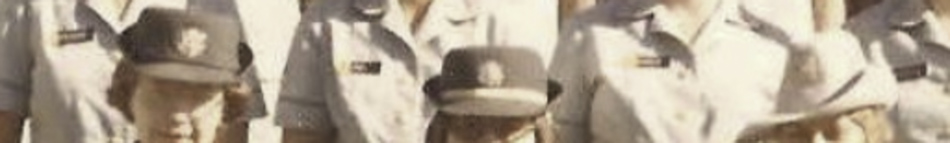 MATTHEW SWARTS A group of people in light-colored uniforms and dark hats, standing close together outdoors. This vintage, slightly blurry image captures their upper bodies and faces, offering a glimpse into the world of fine art photography.