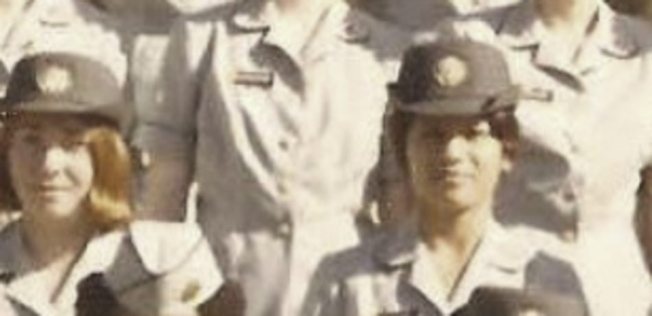 MATTHEW SWARTS A group of women in uniform, wearing hats and name tags, pose for a group photo. The slightly faded, cropped image has the candid feel of contemporary art, focusing on two women in the front row.