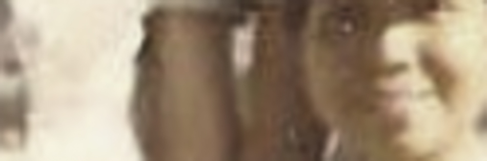 MATTHEW SWARTS A blurry image showing an artist smiling at the camera, with one hand raised to their head. Background details are indistinct, enhancing the sense of fine art photography.