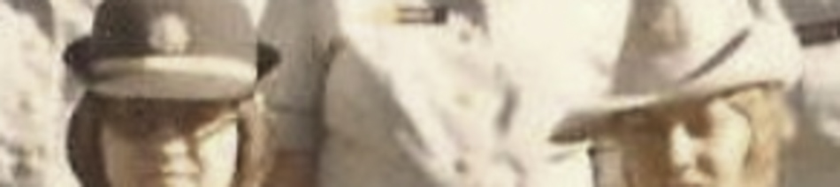 MATTHEW SWARTS Three people in uniform, including two children in hats, stand close together outdoors. The slightly faded photo captures a moment that evokes the timeless quality of visual art, cropped to show only their upper bodies.