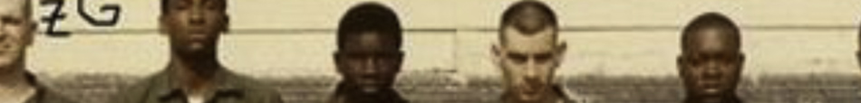 MATTHEW SWARTS A cropped photo in the style of fine art photography shows five young people standing in a row against a wall, facing the camera. Their neutral or serious expressions evoke themes often explored in contemporary art.