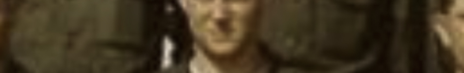 MATTHEW SWARTS A blurry image in the style of fine art photography, showing a person in front of large, dark green objects—possibly bags or backpacks—with very limited facial details visible.