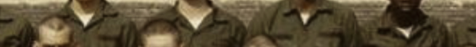 MATTHEW SWARTS A cropped, blurry photo in the style of contemporary art shows five people in olive green uniforms against a light-colored brick wall. Only their upper torsos and heads are partially visible, evoking the touch of a visual artist.