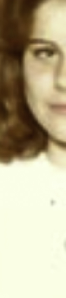 MATTHEW SWARTS A close-up, cropped image in the style of CONTEMPORARY ART shows part of a person's face with wavy reddish-brown hair and fair skin against a light background—reminiscent of MATTHEW SWARTS' evocative portraits. Only part of the eye, nose, and mouth are visible.