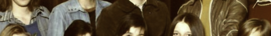MATTHEW SWARTS A cropped vintage photo showing a group of young people, most with long hair and casual clothing, posing together and smiling—a perfect example of fine art photography in the style of Matthew Swarts.