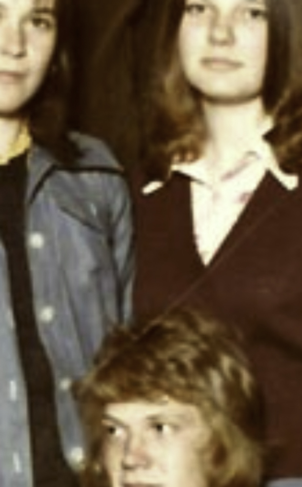 MATTHEW SWARTS A vintage photo showing two young women standing close together and a young person seated in front, all gazing toward the camera. This slightly blurred, cropped image evokes the timeless quality of fine art photography.