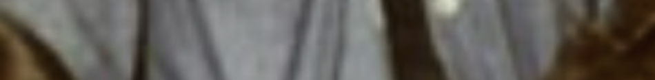 MATTHEW SWARTS A blurred close-up of fabric in neutral tones, possibly clothing, with indistinct vertical and diagonal lines and soft brown and beige colors, evoking the subtle elegance of fine art photography.