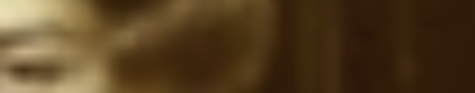MATTHEW SWARTS A blurry close-up image with warm brown and beige tones, this contemporary art piece features an indistinct shape that may be part of a human face and hair. Details are unclear due to the significant blur.