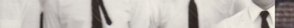 MATTHEW SWARTS A cropped and blurred image in the style of fine art photography, showing people wearing white shirts and dark ties, with only their torsos and part of their necks visible.