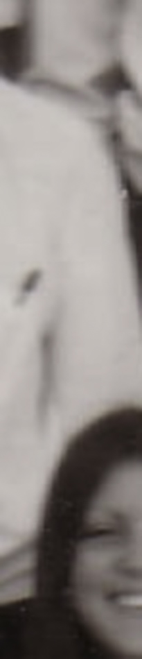 MATTHEW SWARTS A blurry, cropped black-and-white photo in the style of contemporary art by artist Matthew Swarts, showing part of a person’s upper body and the smiling face of another person in the lower corner.
