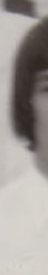 MATTHEW SWARTS A blurry, vertical, black-and-white photo segment by artist Matthew Swarts shows part of a person's face and hair, with unclear details due to the image's cropped and out-of-focus nature—a striking piece of contemporary art.