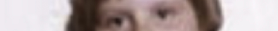 MATTHEW SWARTS A blurry, close-up image in the style of fine art photography showing the eyes and part of the forehead of a person with light skin and brown hair, set against a light background—an evocative work by a true artist.