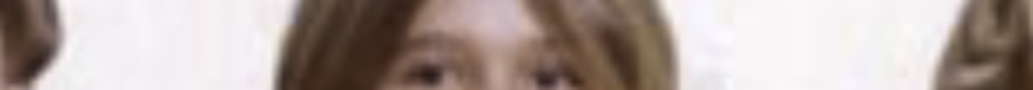 MATTHEW SWARTS A blurred close-up image showing the upper part of a person's face with straight, light brown hair against a pale background, evoking the expressive style of contemporary art.