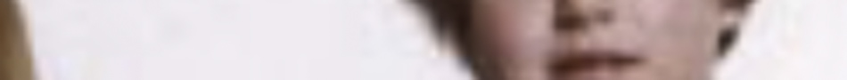 MATTHEW SWARTS A highly blurred close-up image of a person's face, showing part of the mouth and chin. This indistinct portrait evokes contemporary art, reminiscent of Matthew Swarts' abstract explorations of identity.