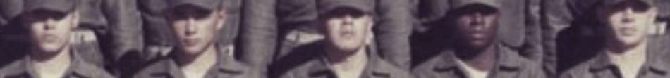 MATTHEW SWARTS A cropped, slightly blurry photo in the style of FINE ART PHOTOGRAPHY shows a row of young men in uniform army attire and caps, standing close together, looking at the camera.