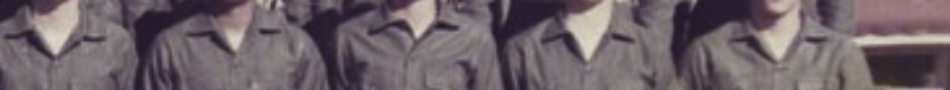 MATTHEW SWARTS A cropped, blurry image of several people in matching coveralls exemplifies FINE ART PHOTOGRAPHY, where the ARTIST obscures faces and background to evoke a sense of anonymity and explore themes within CONTEMPORARY ART.