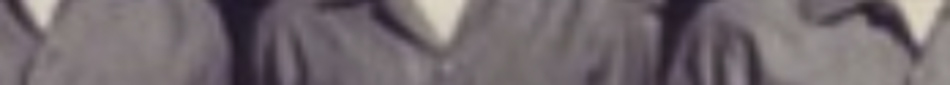 MATTHEW SWARTS A blurred close-up image in the style of fine art photography by artist Matthew Swarts, showing people in muted collared shirts from the shoulders down. No faces are visible, emphasizing form and anonymity.