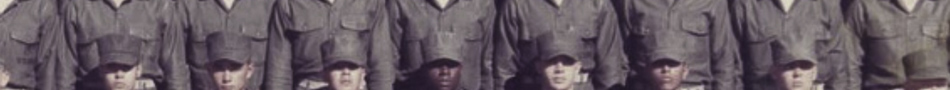 MATTHEW SWARTS A group of people dressed in military uniforms and hats stand in rows for a group photo. The image is cropped, showing only their upper bodies and faces, highlighting the artistry of photography in capturing such moments.