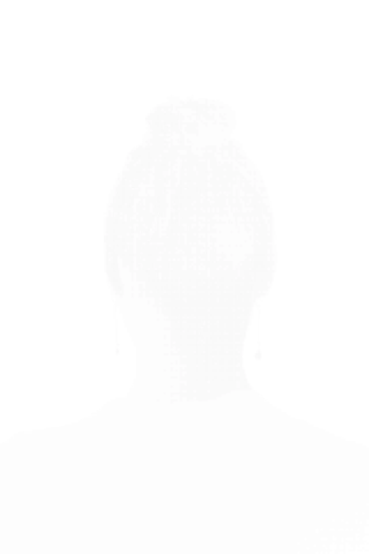 MATTHEW SWARTS A faint, almost invisible silhouette of a person seen from behind, with their hair tied up and wearing dangling earrings, is captured by the photographer against a completely white background—creating a striking visual ART piece.